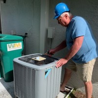 Robert Allen performing an air conditioning inspection