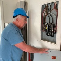 Robert Allen performing an electrical inspection